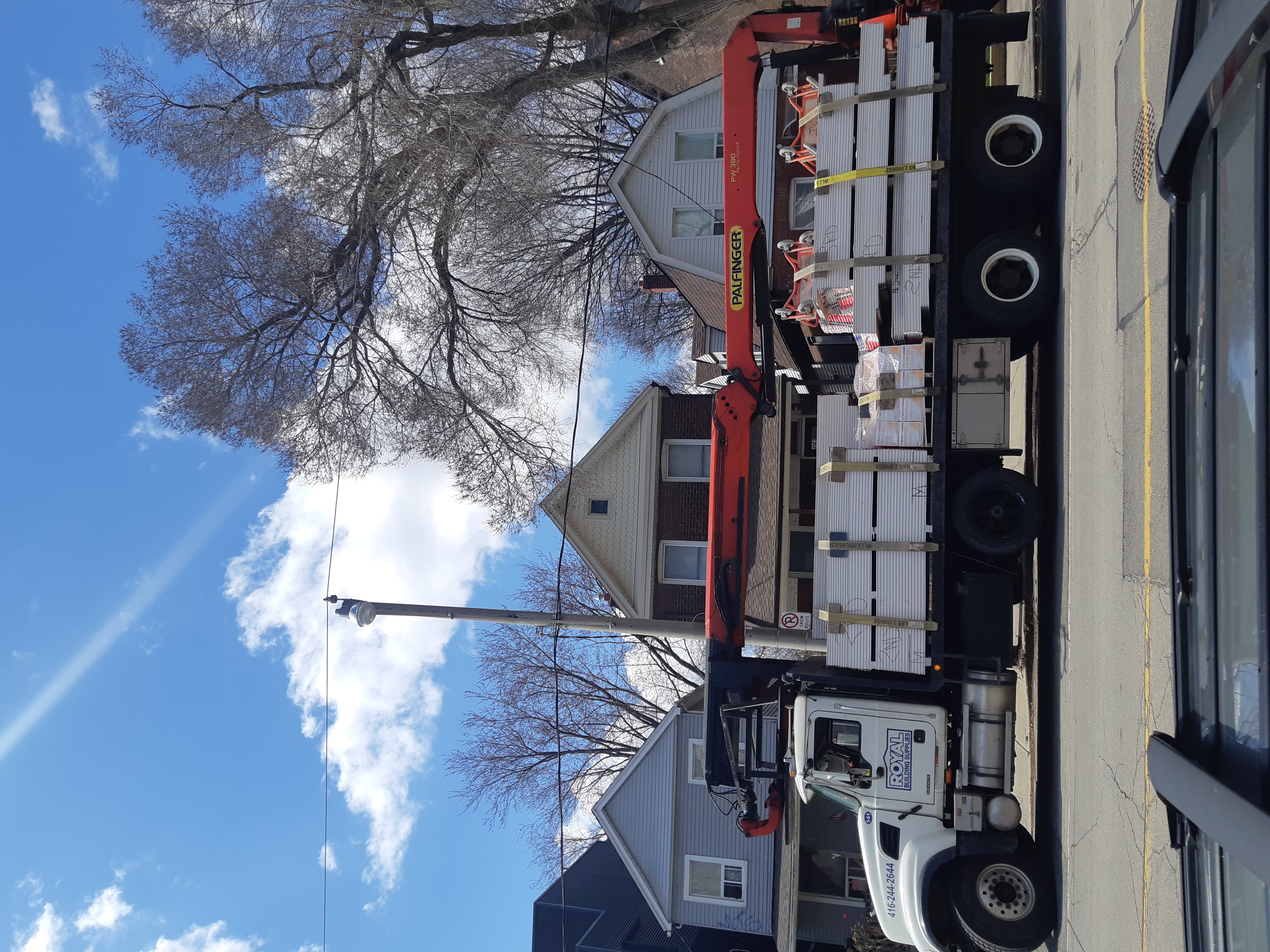 Boom delivery of drywall to construction site