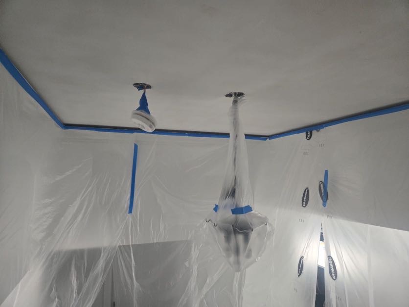 Room fully prepped with poly sheeting and blue tape